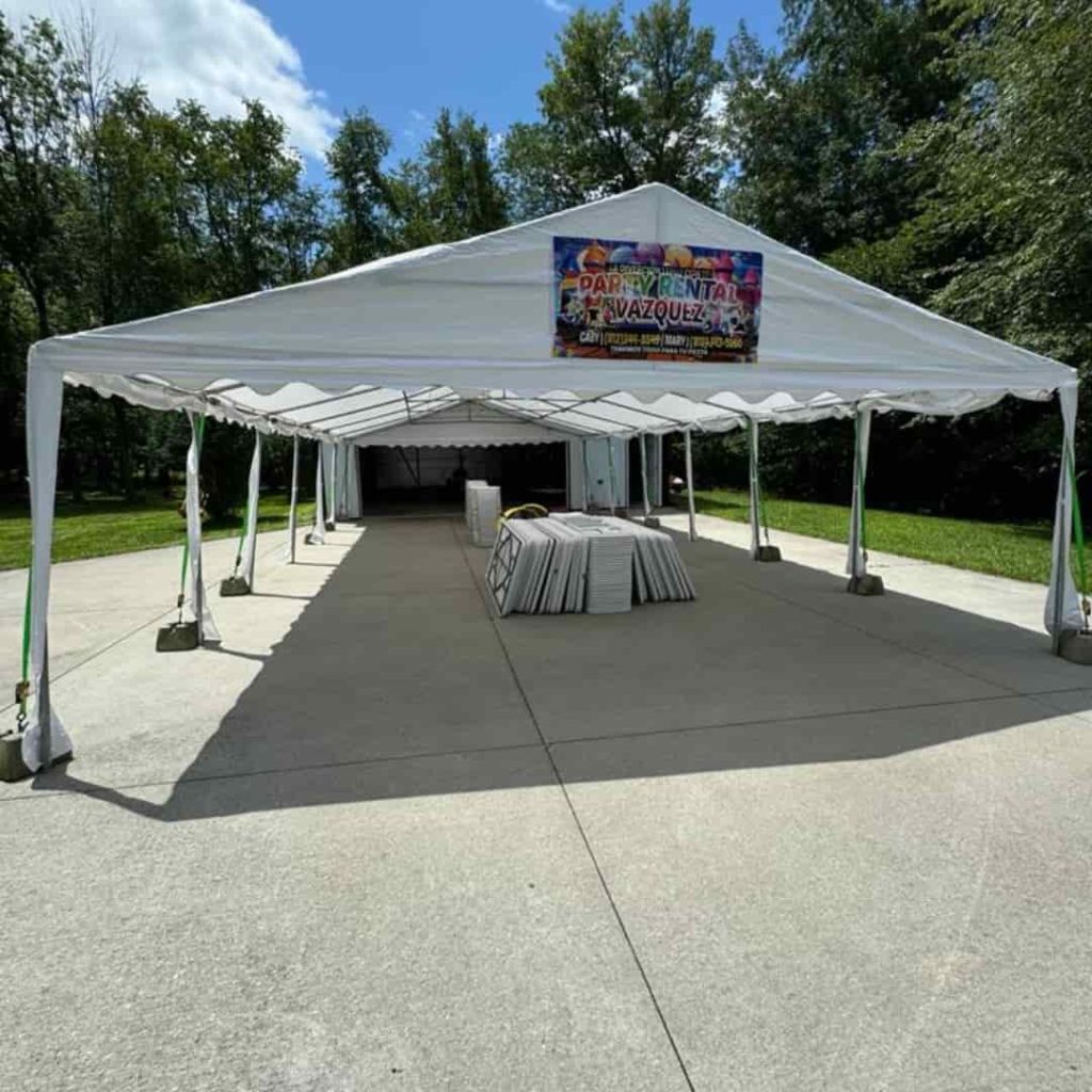 20x40 PE tent rental for 64 guests including 8 round tables and chairs, perfect for weddings, family gatherings, and outdoor celebrations in Columbus, IN.