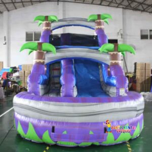 Large purple tropical water slide inflatable rental set up for a party in Columbus, Indiana, great for birthdays, school events, and family celebrations.