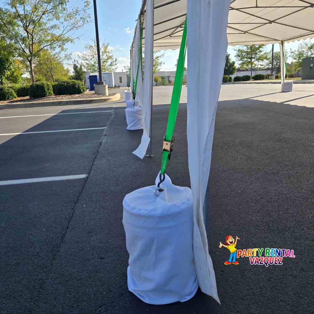 Concrete blocks used to secure a 13x27 PVC tent, strong anchoring solution for party rentals in Columbus Indiana