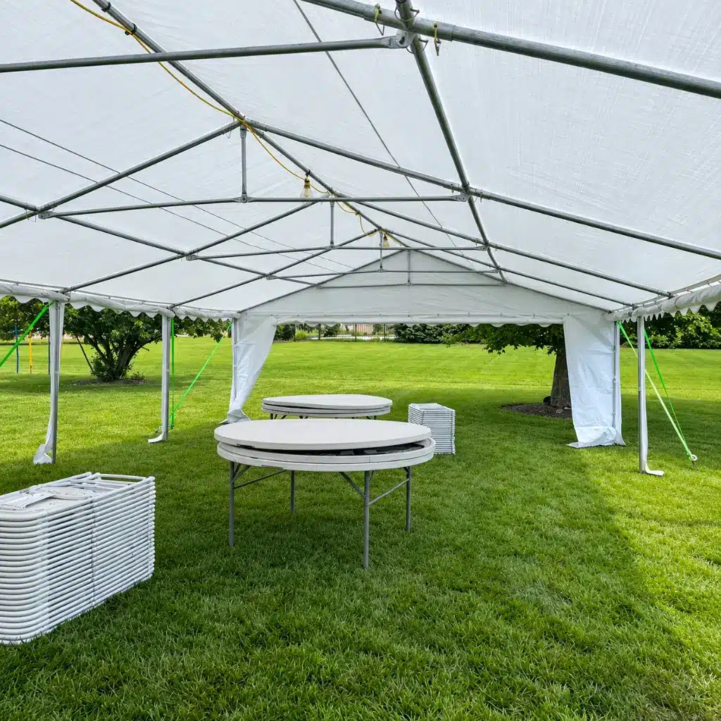 20x40 party tent rental with 8 round tables and 64 chairs for large graduation parties and family events in Columbus, Indiana